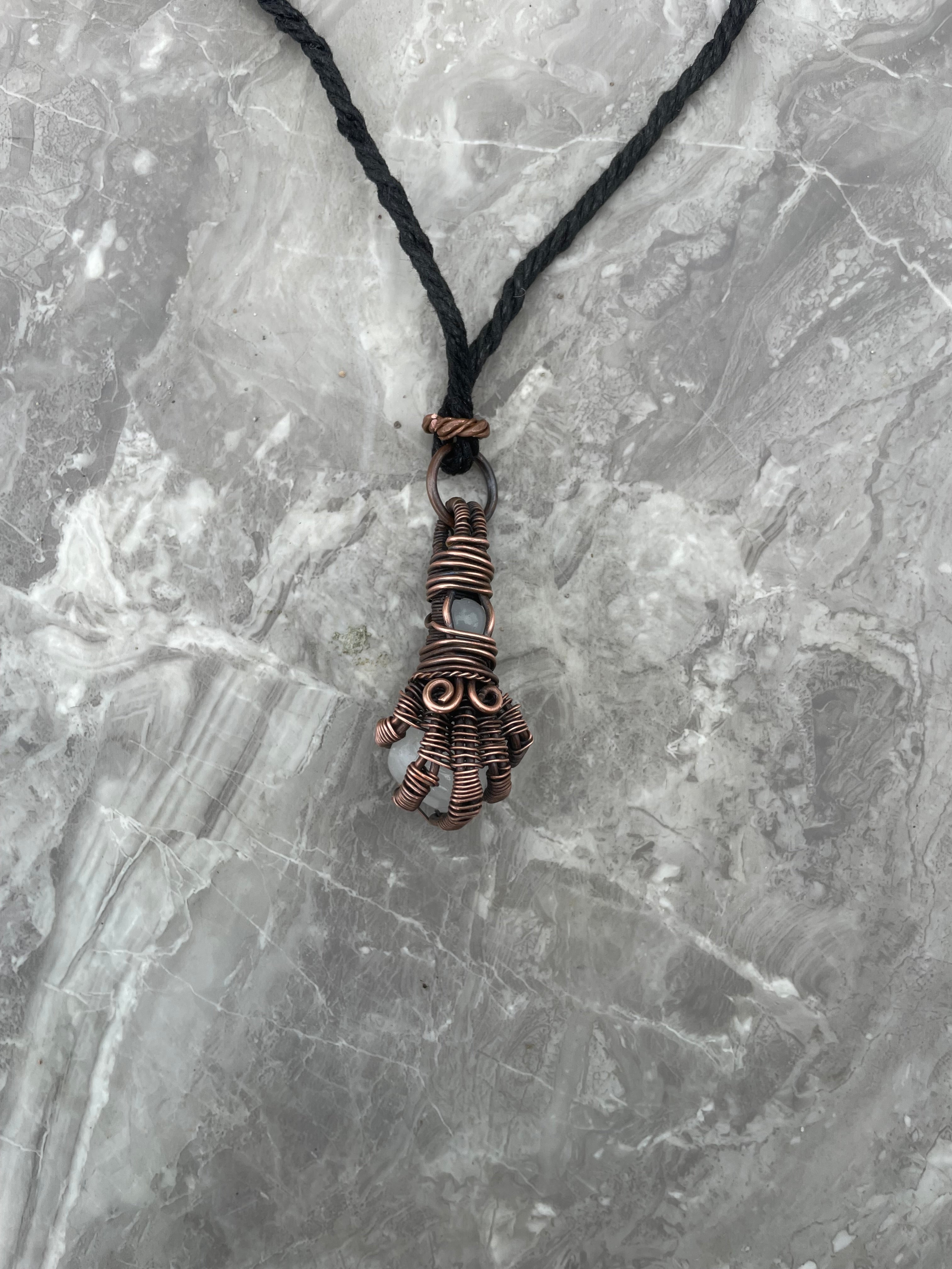 Copper Wire-Wrapped Hand Holding Clear Quartz Necklace