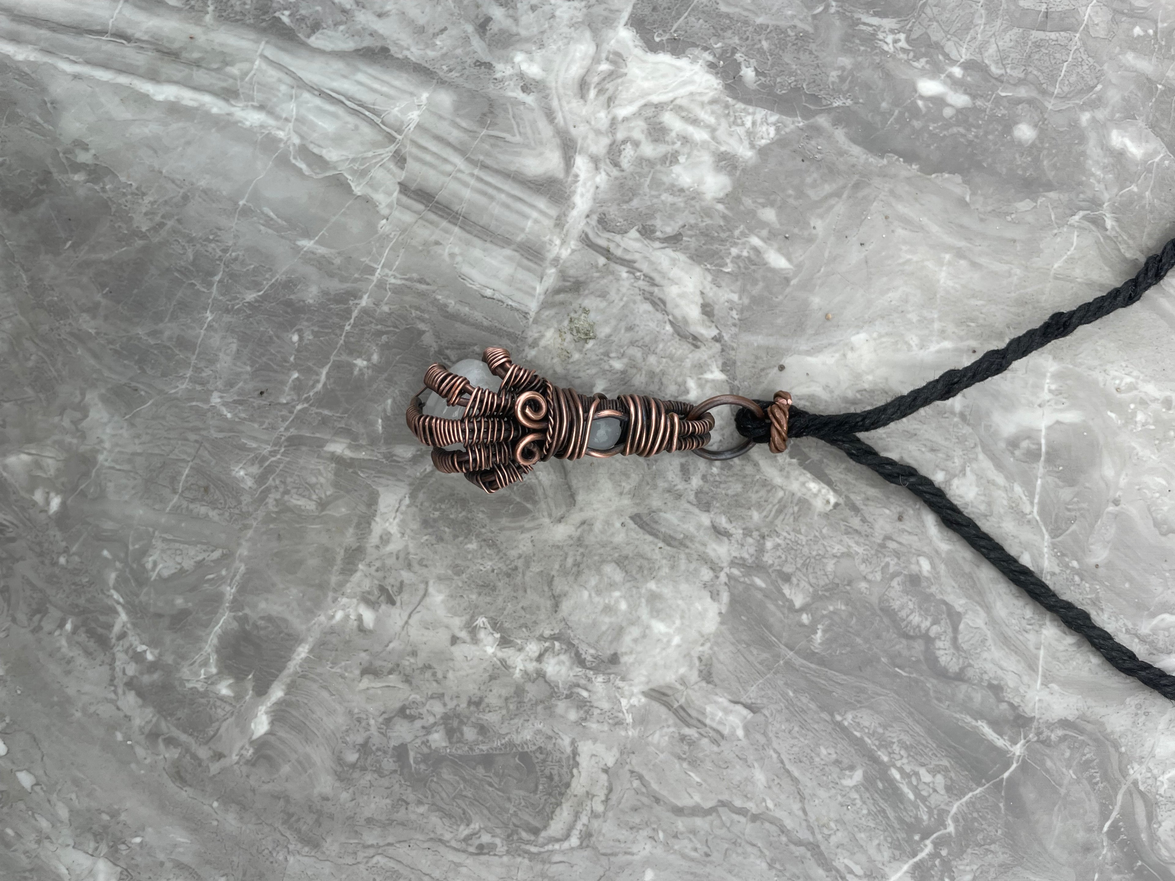Copper Wire-Wrapped Hand Holding Clear Quartz Necklace