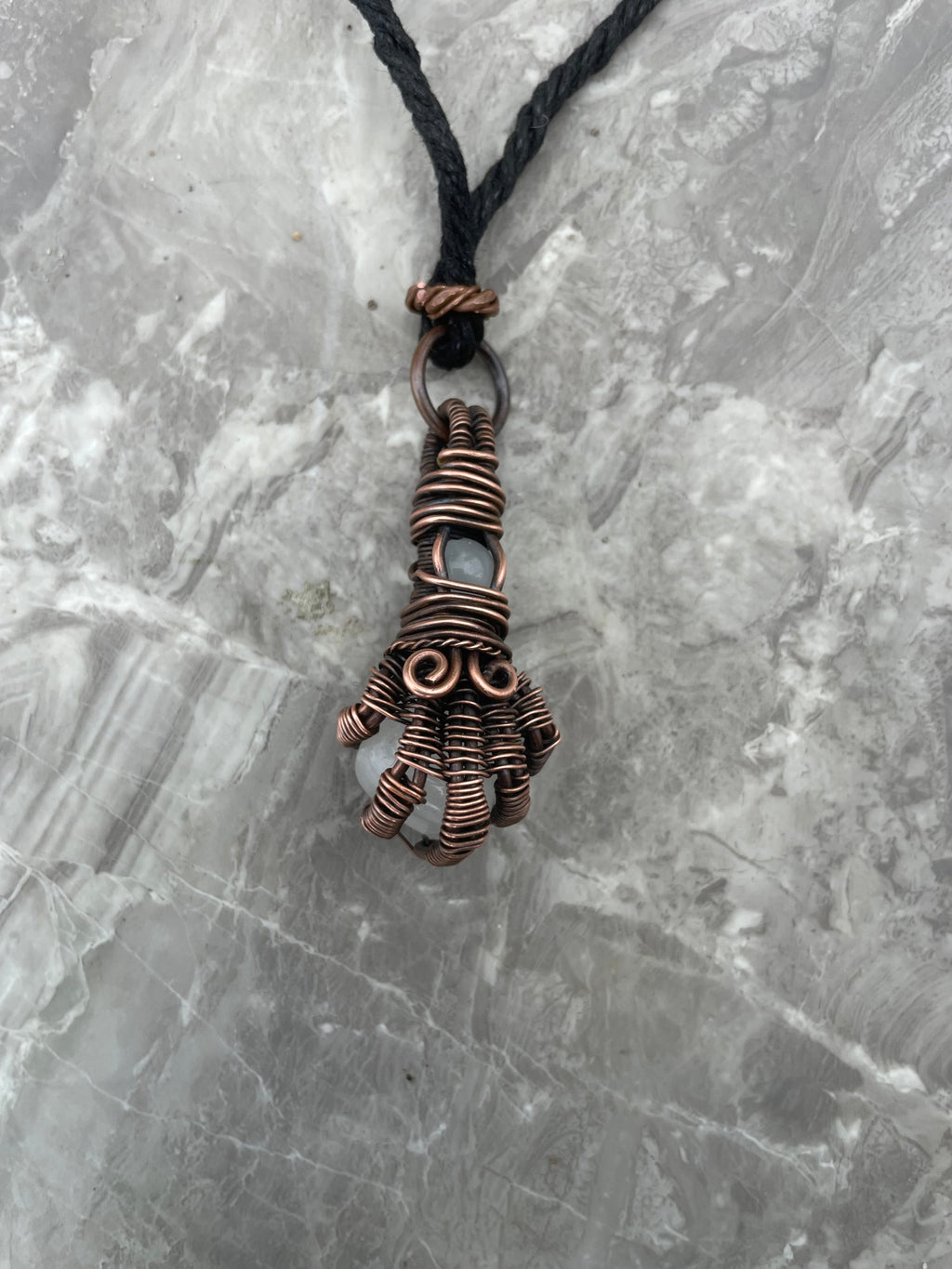 Copper Wire-Wrapped Hand Holding Clear Quartz Necklace