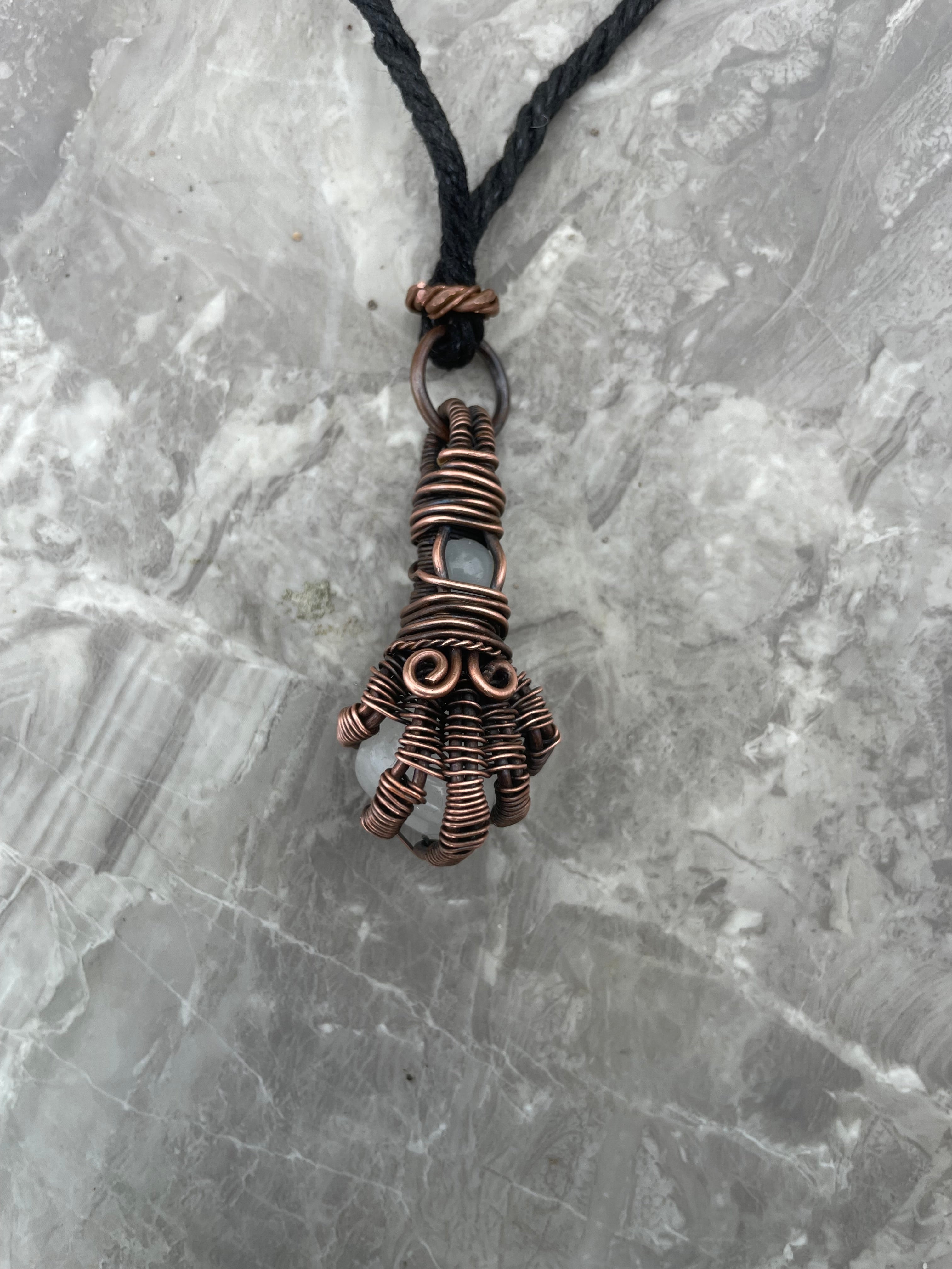 Copper Wire-Wrapped Hand Holding Clear Quartz Necklace