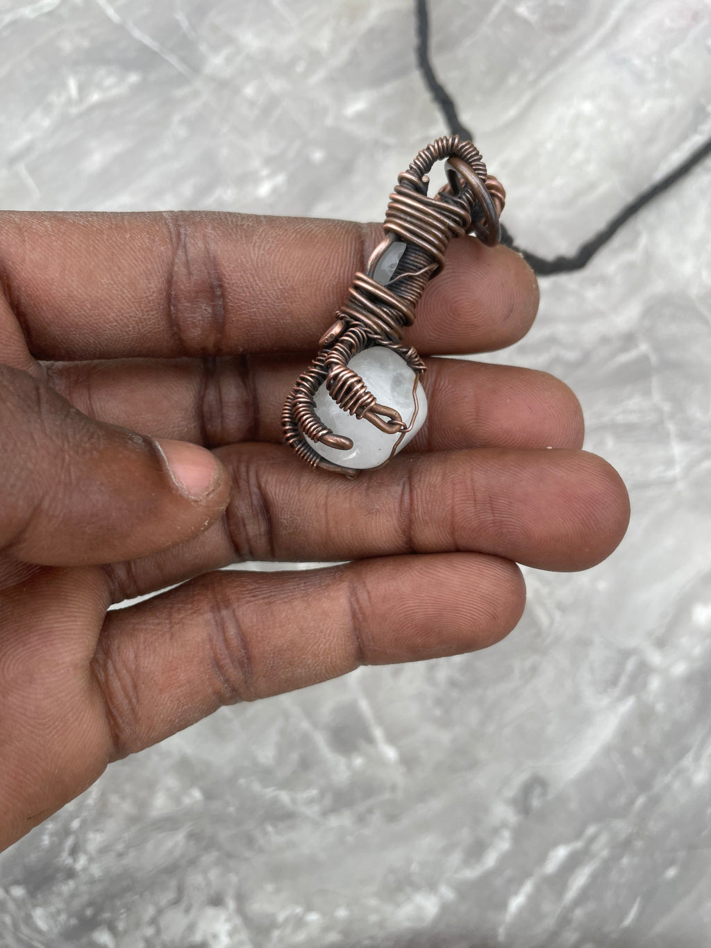 Copper Wire-Wrapped Hand Holding Clear Quartz Necklace