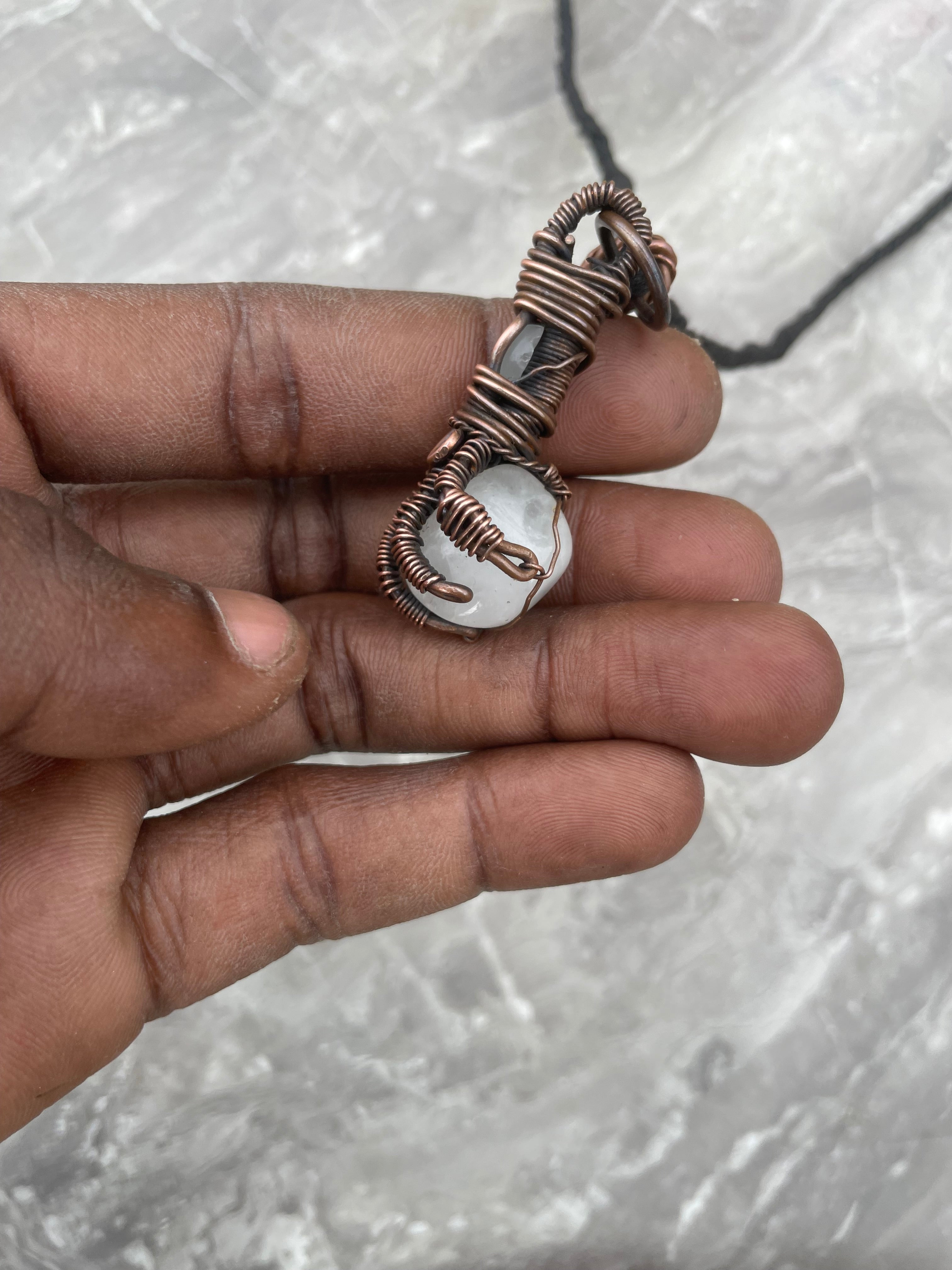 Copper Wire-Wrapped Hand Holding Clear Quartz Necklace