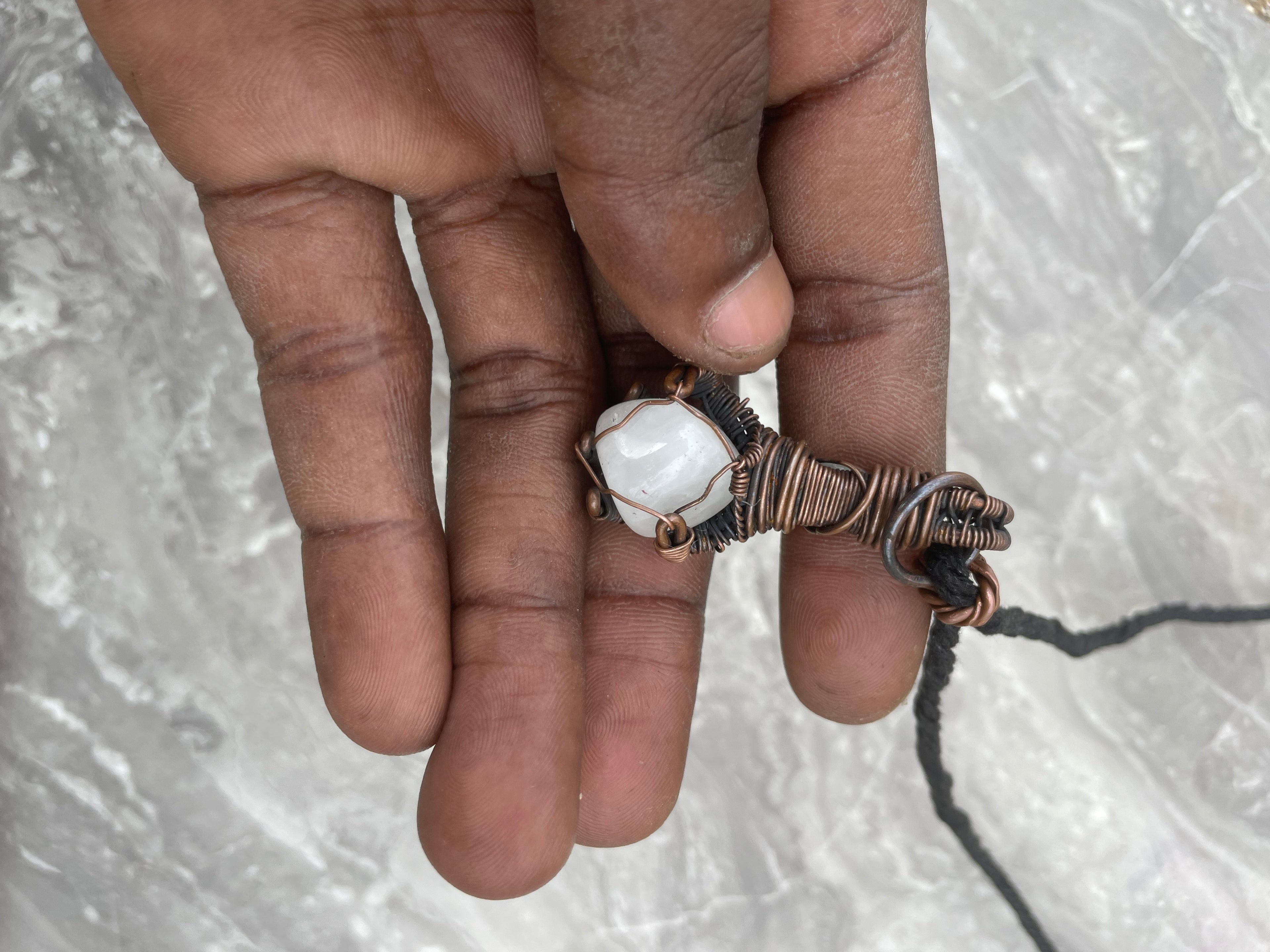 Copper Wire-Wrapped Hand Holding Clear Quartz Necklace