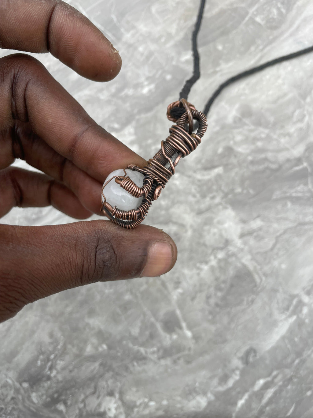 Copper Wire-Wrapped Hand Holding Clear Quartz Necklace